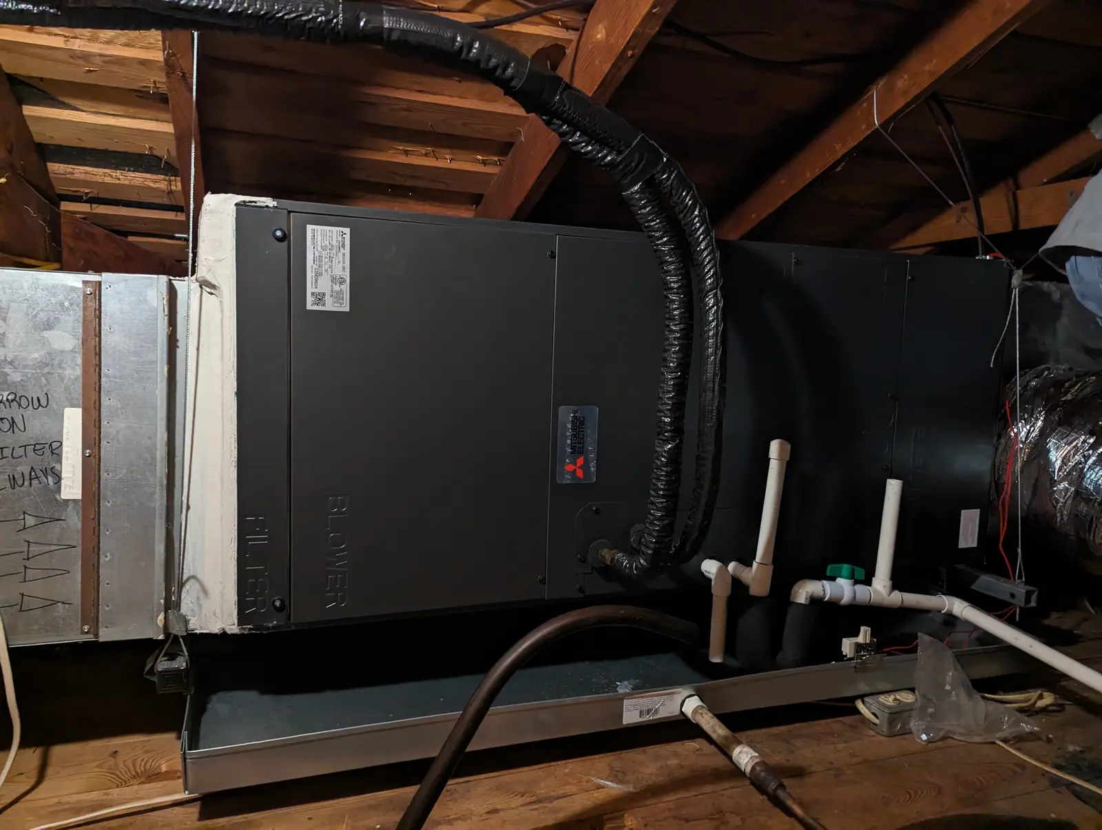 Mitsubishi ducted air handler installed in an attic with condensate lines
