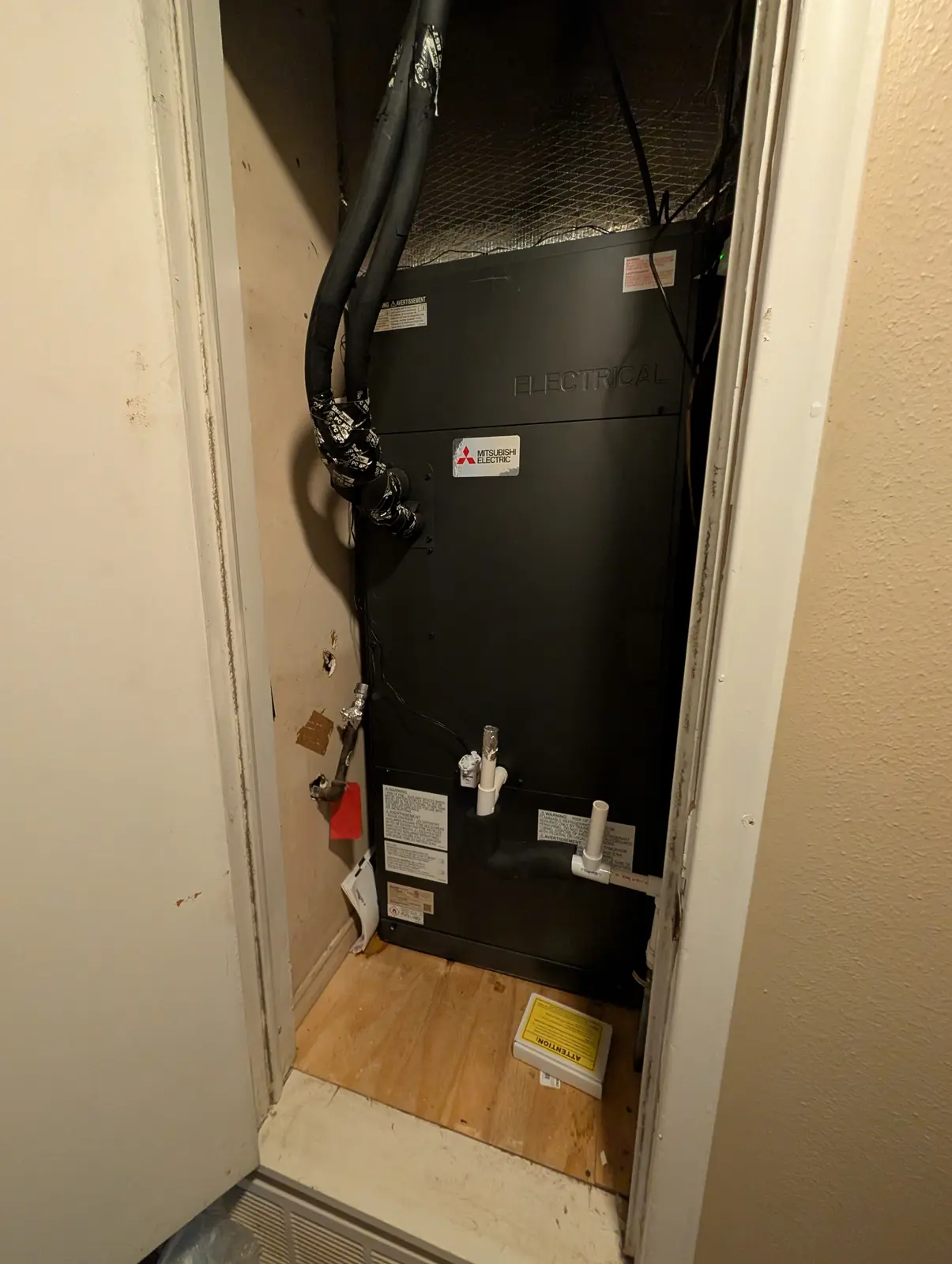 Mitsubishi vertical air handler installed in a narrow utility closet