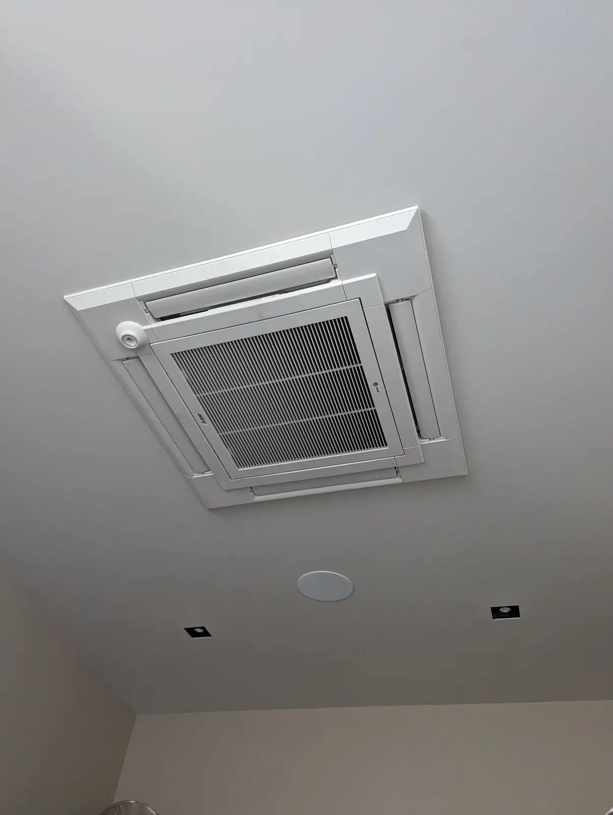 Four-way ceiling cassette mini split in a high white ceiling