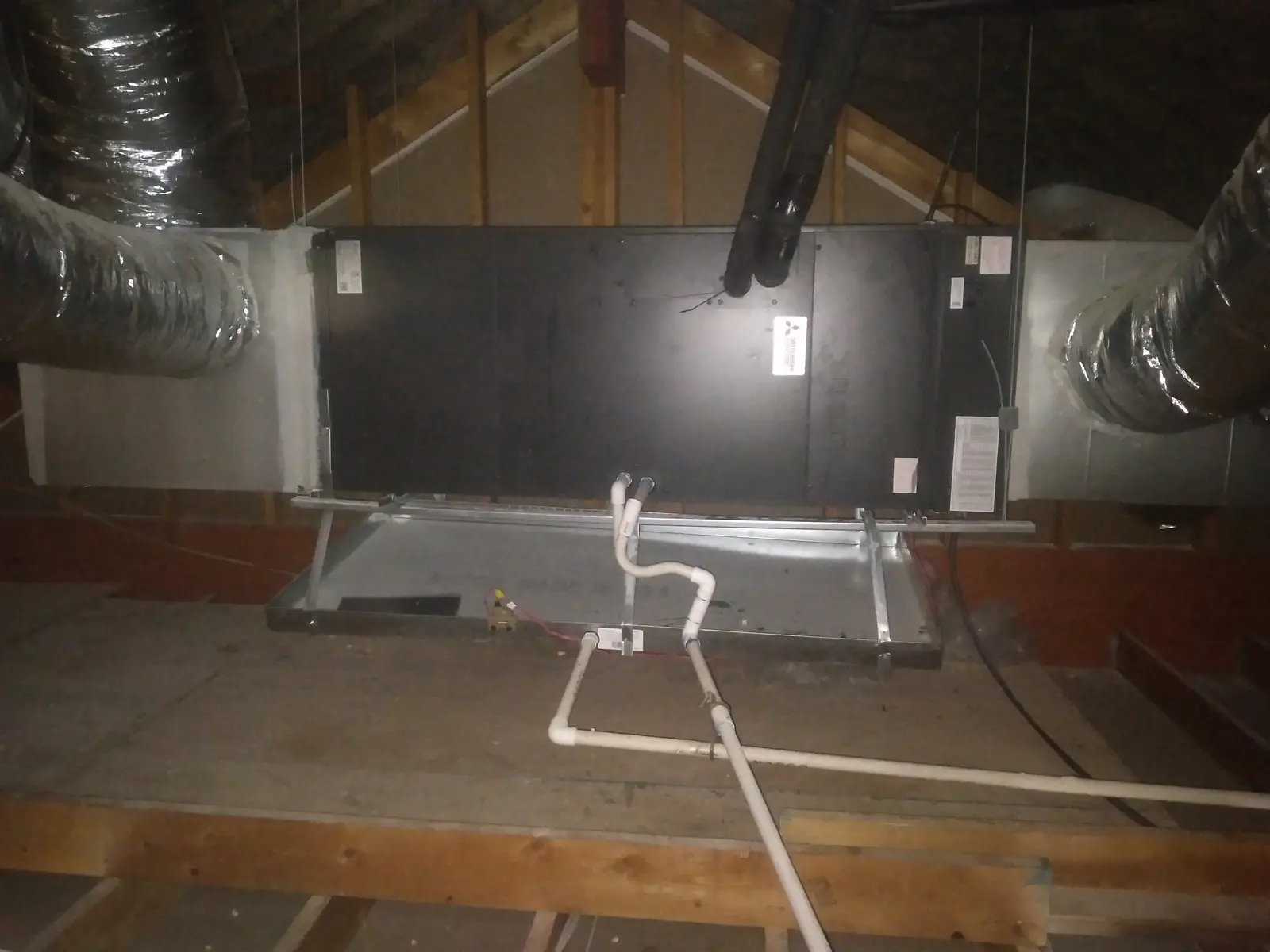 Horizontal ducted mini split air handler installed in an attic with insulated flex ducts
