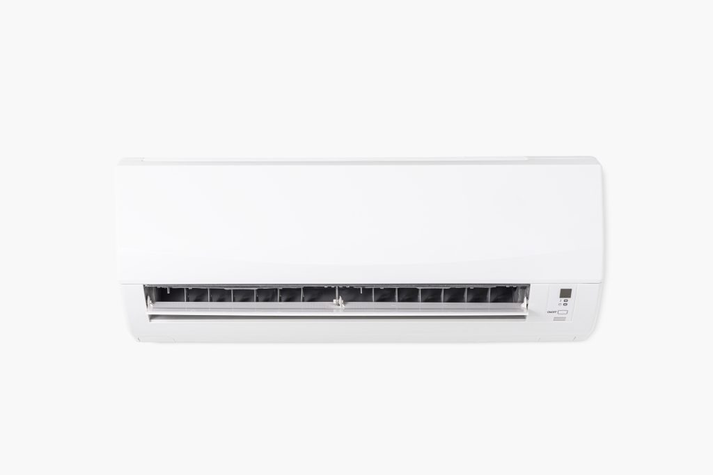 White indoor mini-split air conditioner with open vents and digital display
