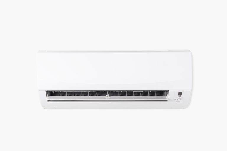 White indoor mini-split air conditioner with open vents and digital display